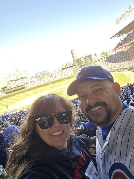 Kevin Macho and his wife, Cassi, smiling in the stands at Wrigley Field