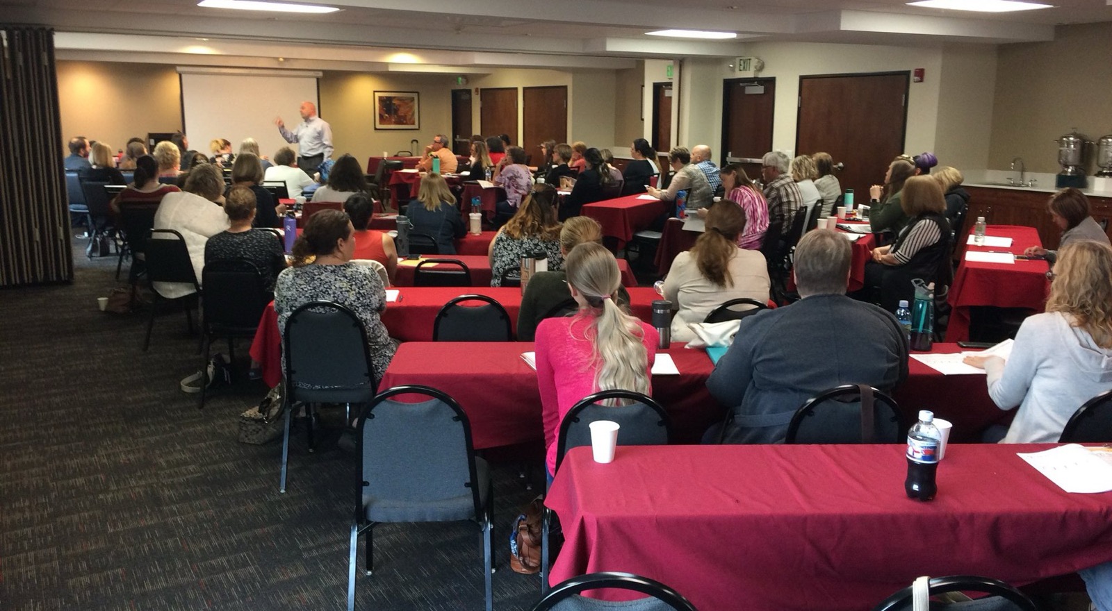 Kevin Macho teaching a full room of managers, supervisors, HR and payroll professionals, and business owners