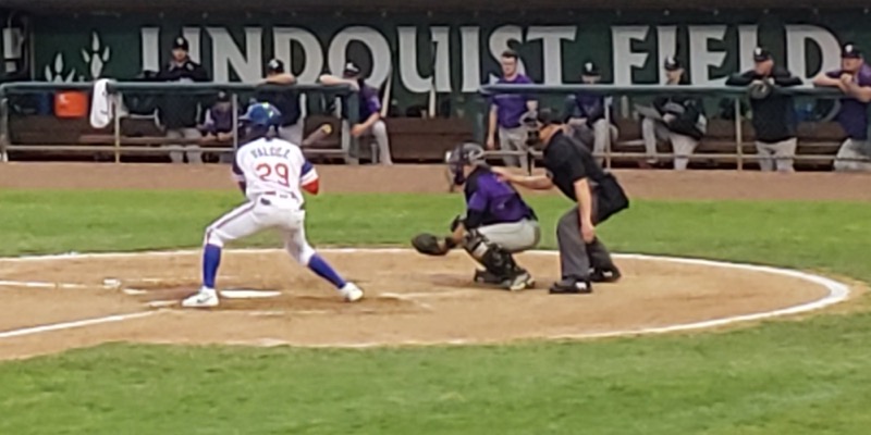 Kevin Macho umpiring behind the plate at a professional baseball game at Lindquist Field in Ogden, Utah